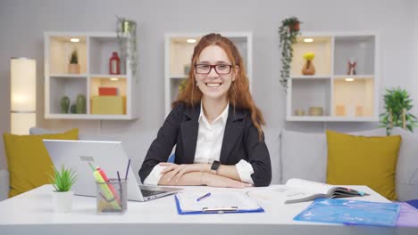 Home-office-worker-woman-smiling-at-camera.